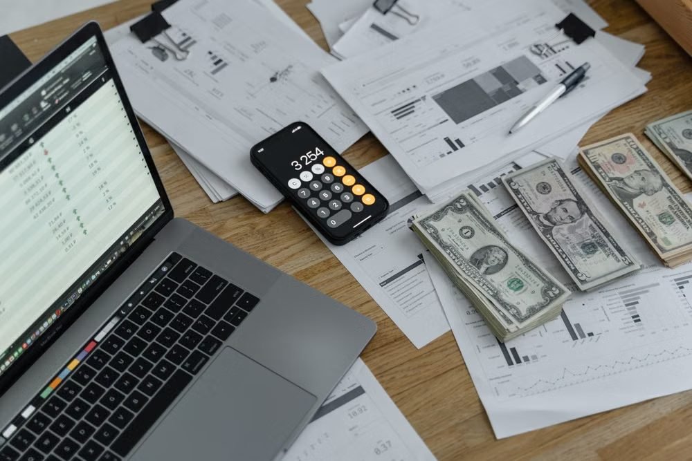 Cédulas de dinheiro e calculadora sobre a mesa
